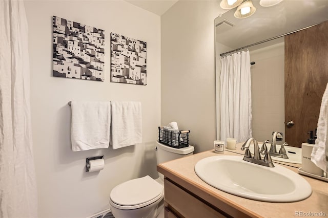 bathroom with vanity, toilet, and walk in shower