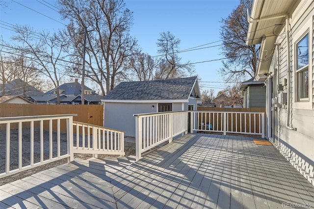 deck with an outdoor structure and fence