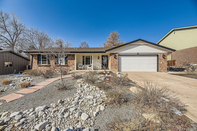 ranch-style home featuring a garage, concrete driveway, and brick siding