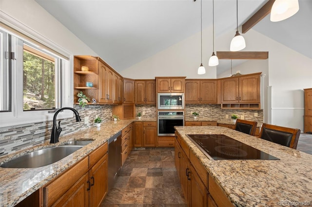kitchen with appliances with stainless steel finishes, a sink, brown cabinets, pendant lighting, and light stone countertops