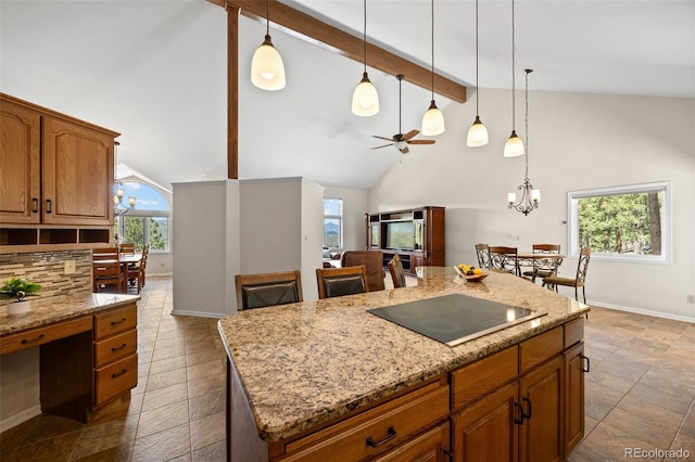 kitchen with black electric cooktop, beam ceiling, baseboards, brown cabinetry, and a chandelier