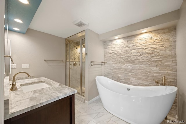full bathroom featuring vanity, a stall shower, recessed lighting, a freestanding tub, and marble finish flooring
