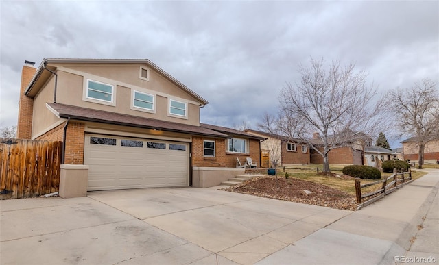 traditional-style home featuring driveway, brick siding, a chimney, fence, and stucco siding