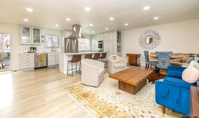 living room featuring light wood finished floors and recessed lighting