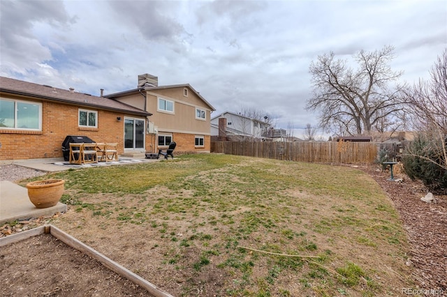 view of yard featuring a patio area and a fenced backyard