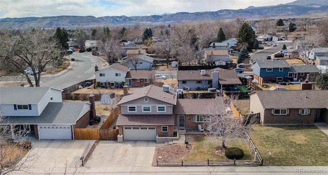 birds eye view of property featuring a mountain view and a residential view