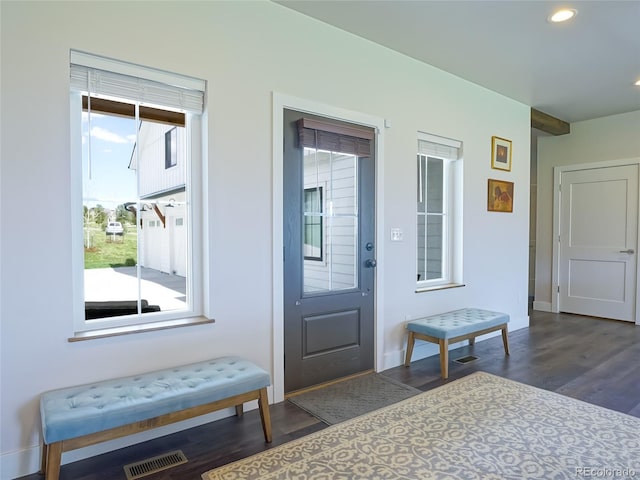 doorway to outside with visible vents, recessed lighting, dark wood finished floors, and baseboards