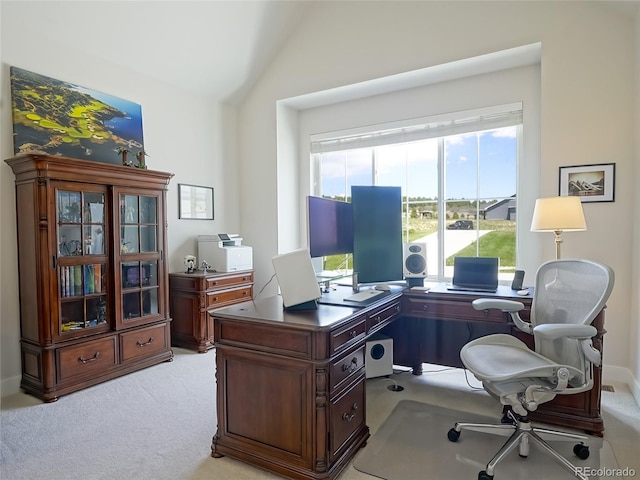 office space featuring vaulted ceiling and light carpet