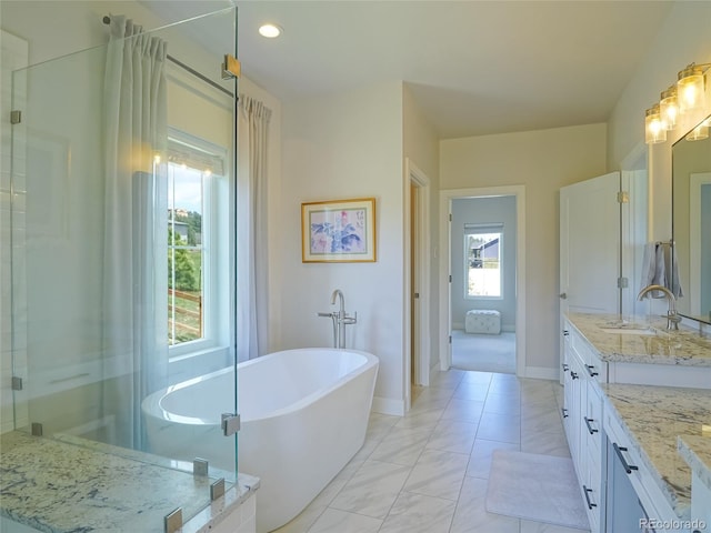 bathroom featuring a shower with shower door, vanity, baseboards, marble finish floor, and a soaking tub