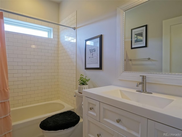 full bath featuring vanity, shower / bath combo with shower curtain, and toilet