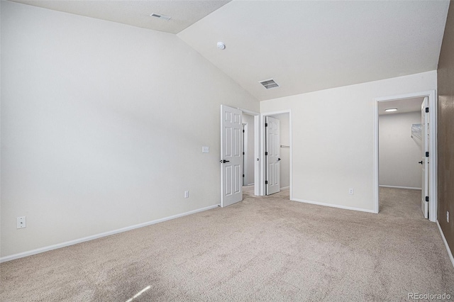 12710 Jasmine St Unit C, Thornton, CO 80602 - unfurnished bedroom with visible vents, vaulted ceiling, light colored carpet, and a spacious closet