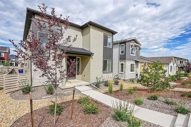 view of front of house featuring fence