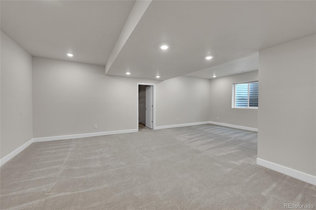 below grade area featuring recessed lighting, light carpet, and baseboards