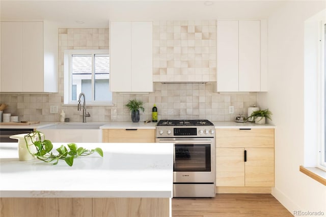 4631 Zuni St, Denver, CO 80211 - kitchen with stainless steel range with gas cooktop, a sink, modern cabinets, and light countertops