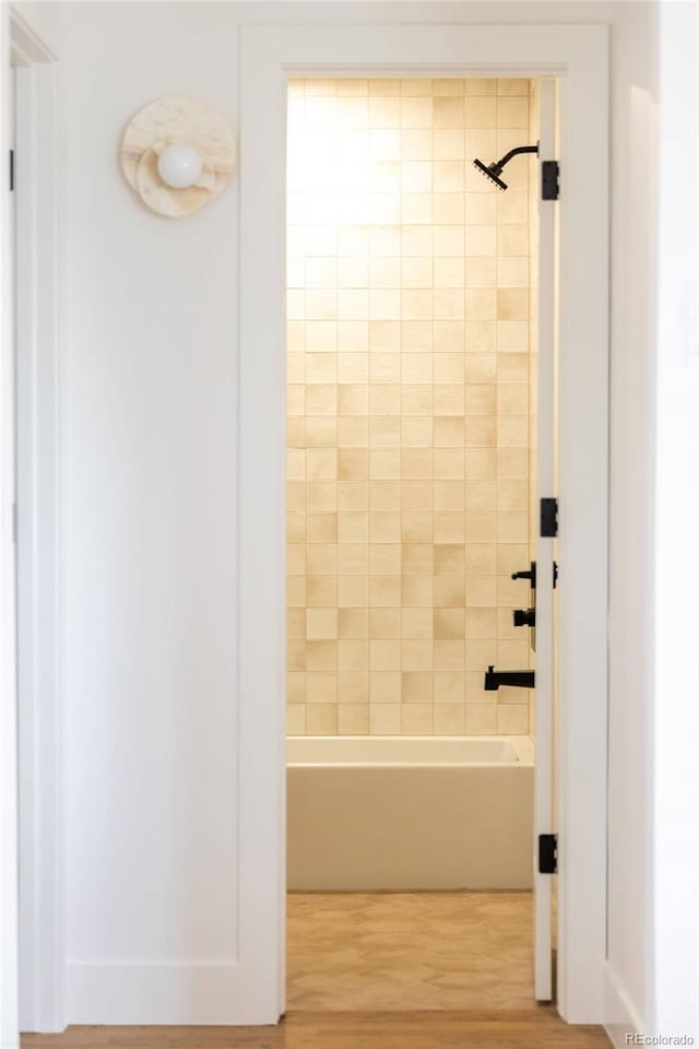 4631 Zuni St, Denver, CO 80211 - bathroom featuring tub / shower combination and wood finished floors