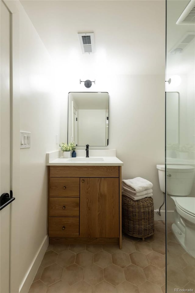4631 Zuni St, Denver, CO 80211 - bathroom featuring toilet, tile patterned flooring, vanity, and baseboards