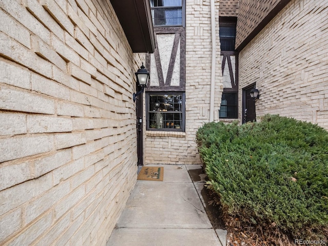 view of exterior entry featuring brick siding