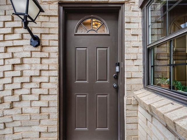 property entrance featuring stone siding