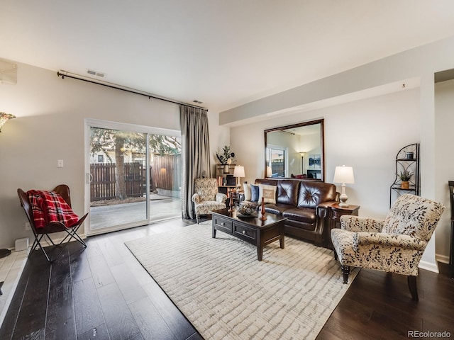 living area featuring hardwood / wood-style floors and visible vents