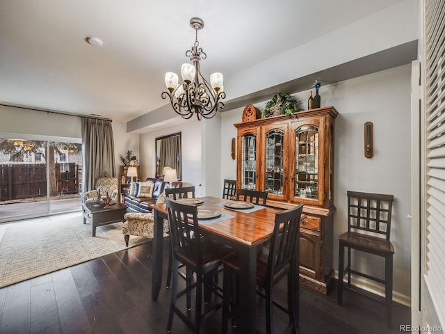 dining space featuring a chandelier and dark wood-style flooring