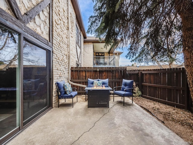 view of patio with a fire pit and fence