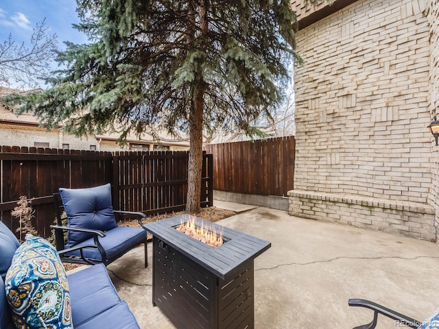 view of patio with an outdoor fire pit and a fenced backyard