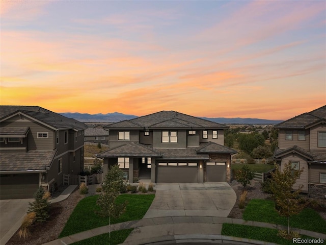 16371 Jones Mountain Way, Broomfield, CO 80023 - prairie-style home with a garage, driveway, a mountain view, and stucco siding