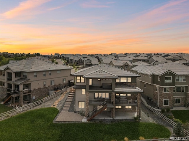 16371 Jones Mountain Way, Broomfield, CO 80023 - back of property with a patio, stairway, a residential view, a balcony, and stone siding