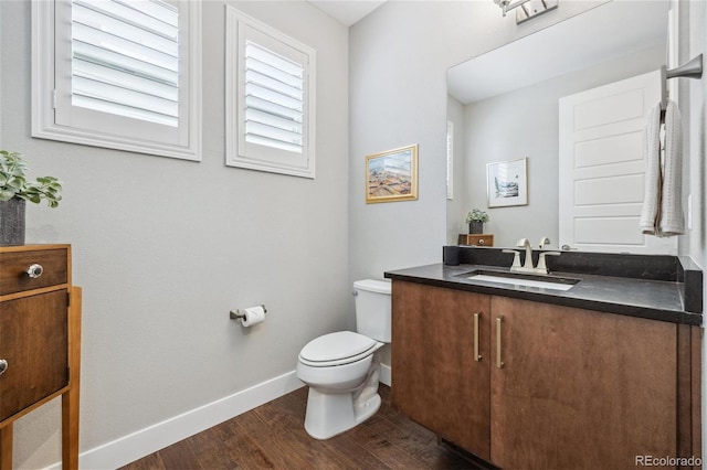 16371 Jones Mountain Way, Broomfield, CO 80023 - bathroom with vanity, wood finished floors, toilet, and baseboards