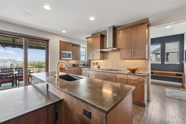16371 Jones Mountain Way, Broomfield, CO 80023 - kitchen with appliances with stainless steel finishes, wall chimney range hood, a sink, healthy amount of natural light, and recessed lighting