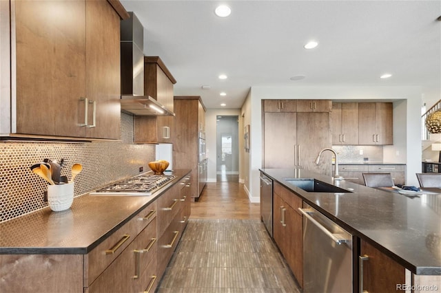16371 Jones Mountain Way, Broomfield, CO 80023 - kitchen with a sink, appliances with stainless steel finishes, wall chimney exhaust hood, recessed lighting, and baseboards
