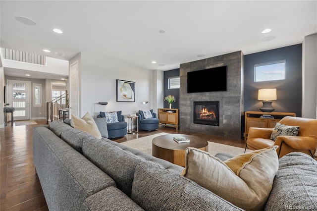 16371 Jones Mountain Way, Broomfield, CO 80023 - living room with recessed lighting, a tiled fireplace, healthy amount of natural light, wood finished floors, and baseboards