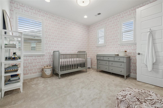 16371 Jones Mountain Way, Broomfield, CO 80023 - carpeted bedroom with wallpapered walls, a crib, and baseboards