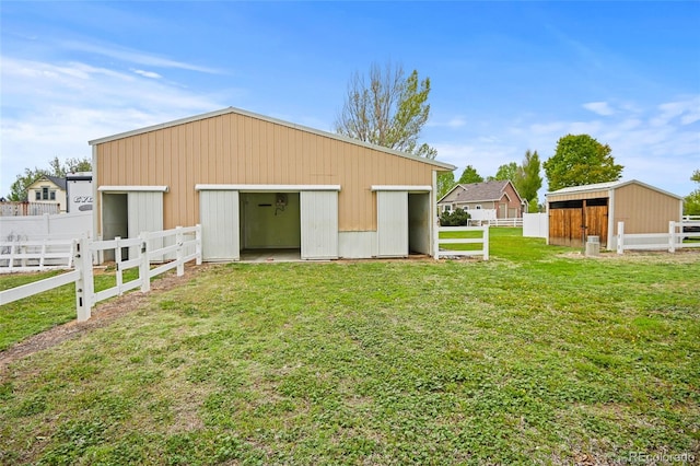 view of outbuilding with a yard