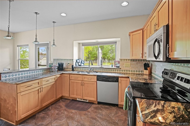 kitchen with stainless steel appliances, dark tile patterned floors, sink, decorative light fixtures, and backsplash