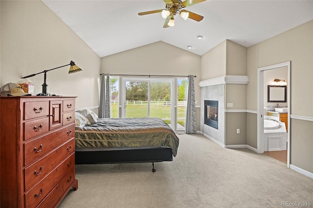 bedroom with a tile fireplace, light carpet, ceiling fan, access to outside, and lofted ceiling