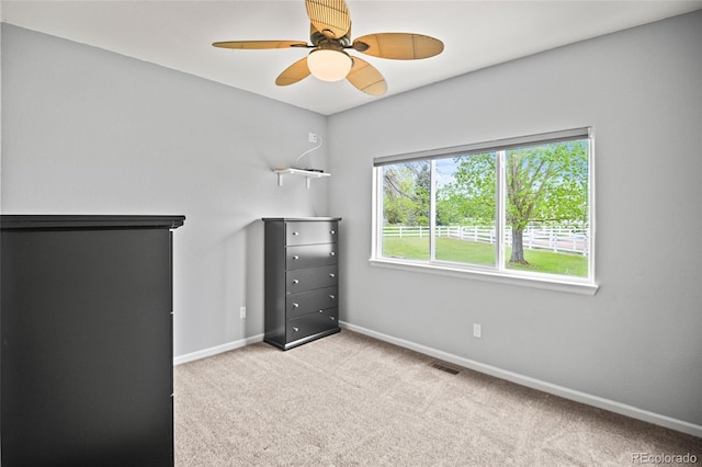 unfurnished bedroom with ceiling fan and light colored carpet