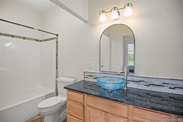 full bathroom featuring toilet, shower / bathing tub combination, backsplash, and vanity