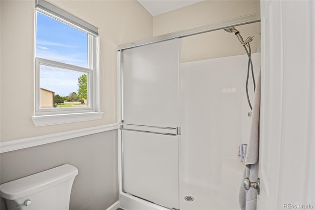 bathroom with toilet and walk in shower