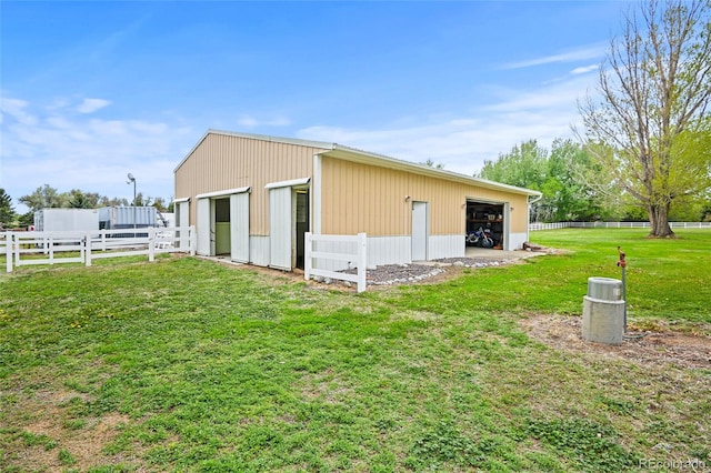 view of home's exterior featuring a lawn and an outdoor structure