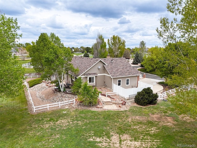 back of house with a lawn