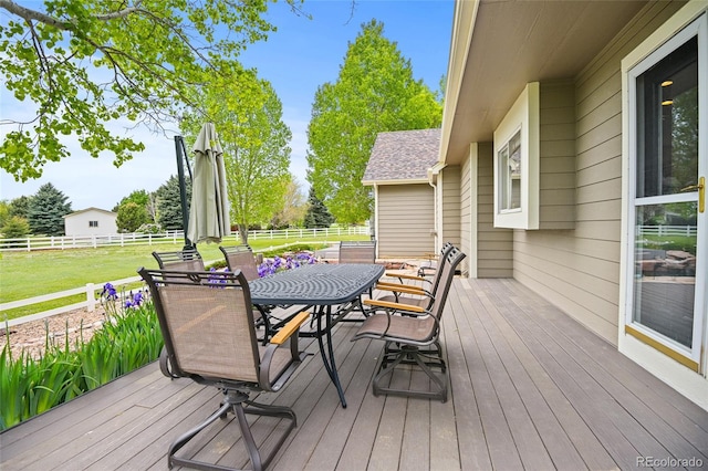 wooden deck with a lawn