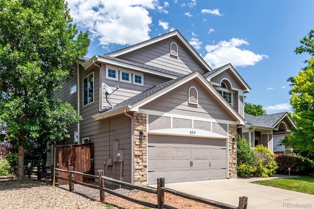 664 Clarendon Dr, Longmont, CO 80504 - view of front of property with stone siding, concrete driveway, a garage, and a shingled roof
