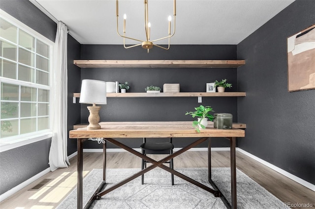 664 Clarendon Dr, Longmont, CO 80504 - office area featuring a chandelier, wood finished floors, and a textured wall