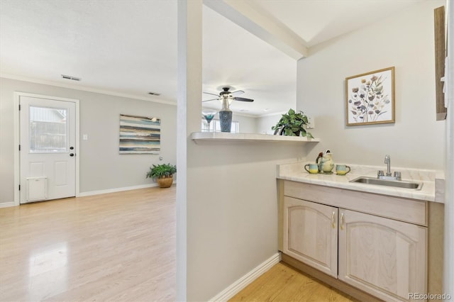 bathroom with ornamental molding, ceiling fan, baseboards, and wood finished floors