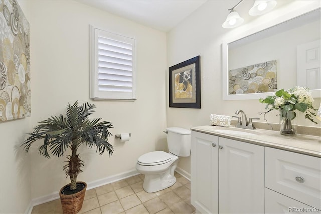 bathroom featuring vanity, tile patterned floors, toilet, and baseboards