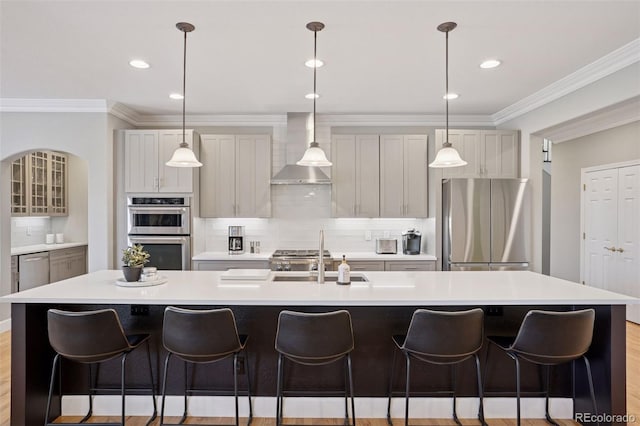 22419 Springflower Dr, Golden, CO 80401 - kitchen with wall chimney exhaust hood, a sink, appliances with stainless steel finishes, an island with sink, and backsplash