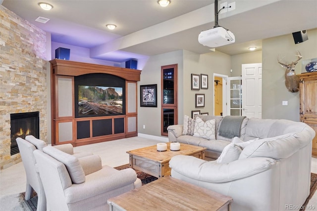 22419 Springflower Dr, Golden, CO 80401 - living room featuring carpet flooring, visible vents, a stone fireplace, and baseboards