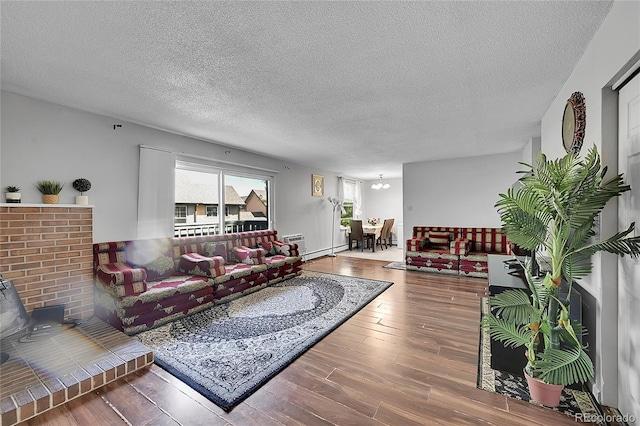 living room with a textured ceiling and wood-type flooring