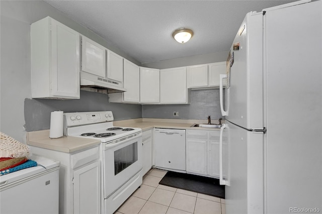 kitchen with light tile patterned flooring, white cabinetry, and white appliances